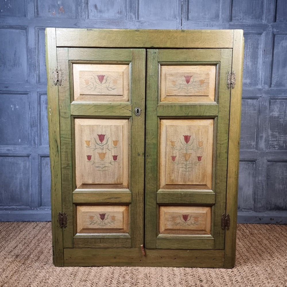 An 18th Century Green Painted Corner Cupboard.