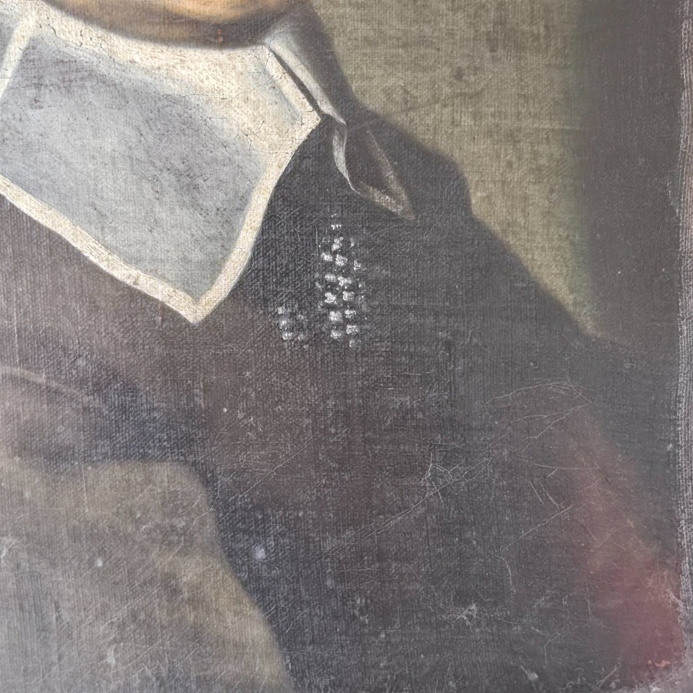 An antique oil painting depicting a 17th-century gentleman with dark hair and a white collar, presented in a dark ebonised frame. View VI