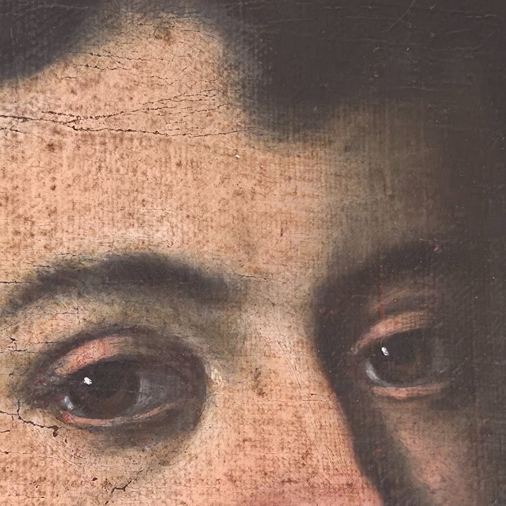 An antique oil painting depicting a 17th-century gentleman with dark hair and a white collar, presented in a dark ebonised frame. View IX
