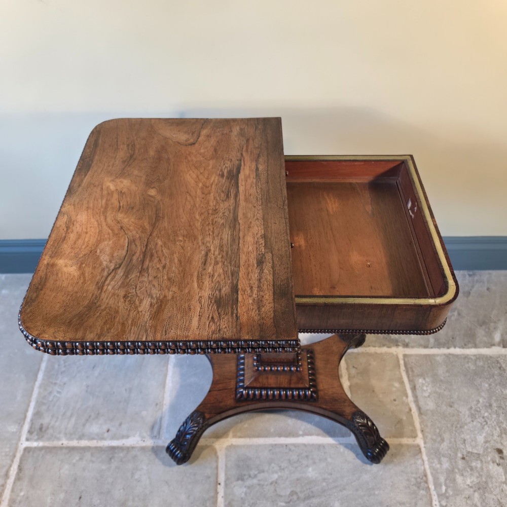 A William IV rosewood pedestal card table with a green baize playing surface, bead moulding, and carved scroll feet. View VII