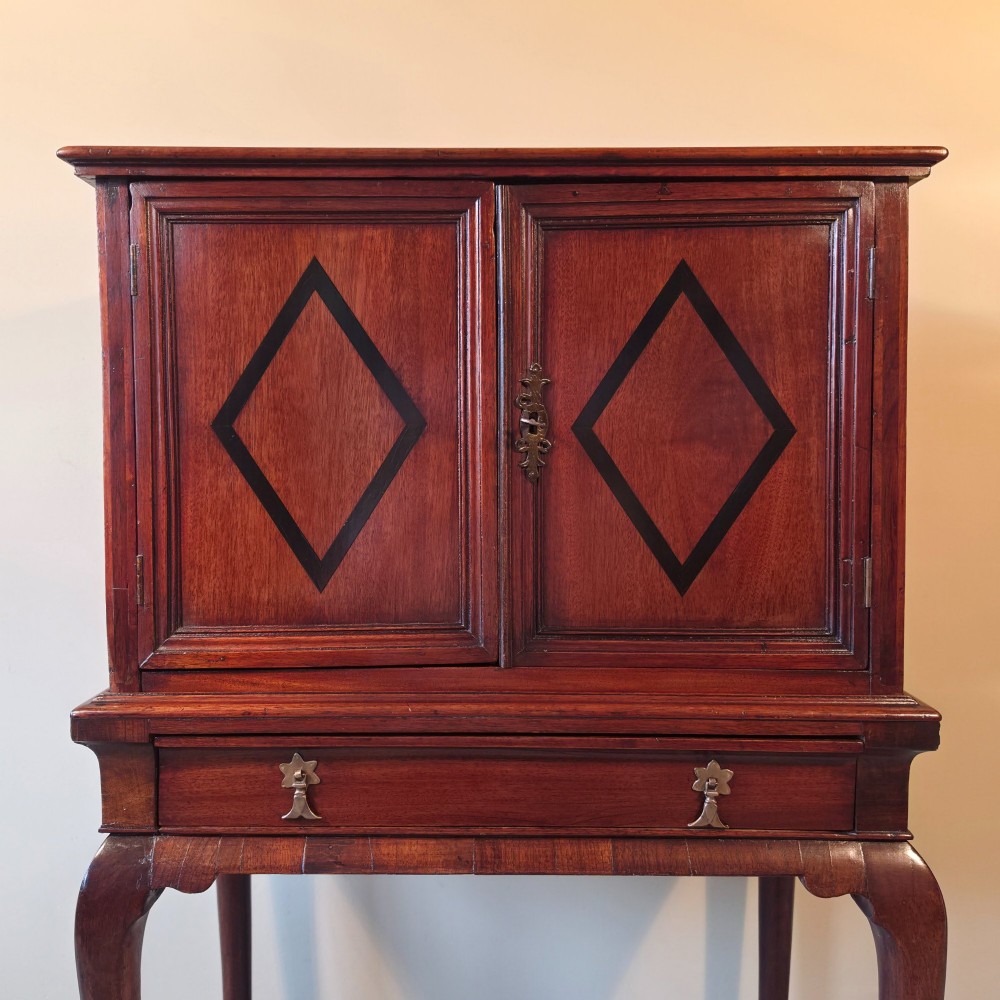 An 18th-century dark wood cabinet on stand featuring twin doors with black diamond inlay, a single lower drawer, and slender cabriole legs. View III