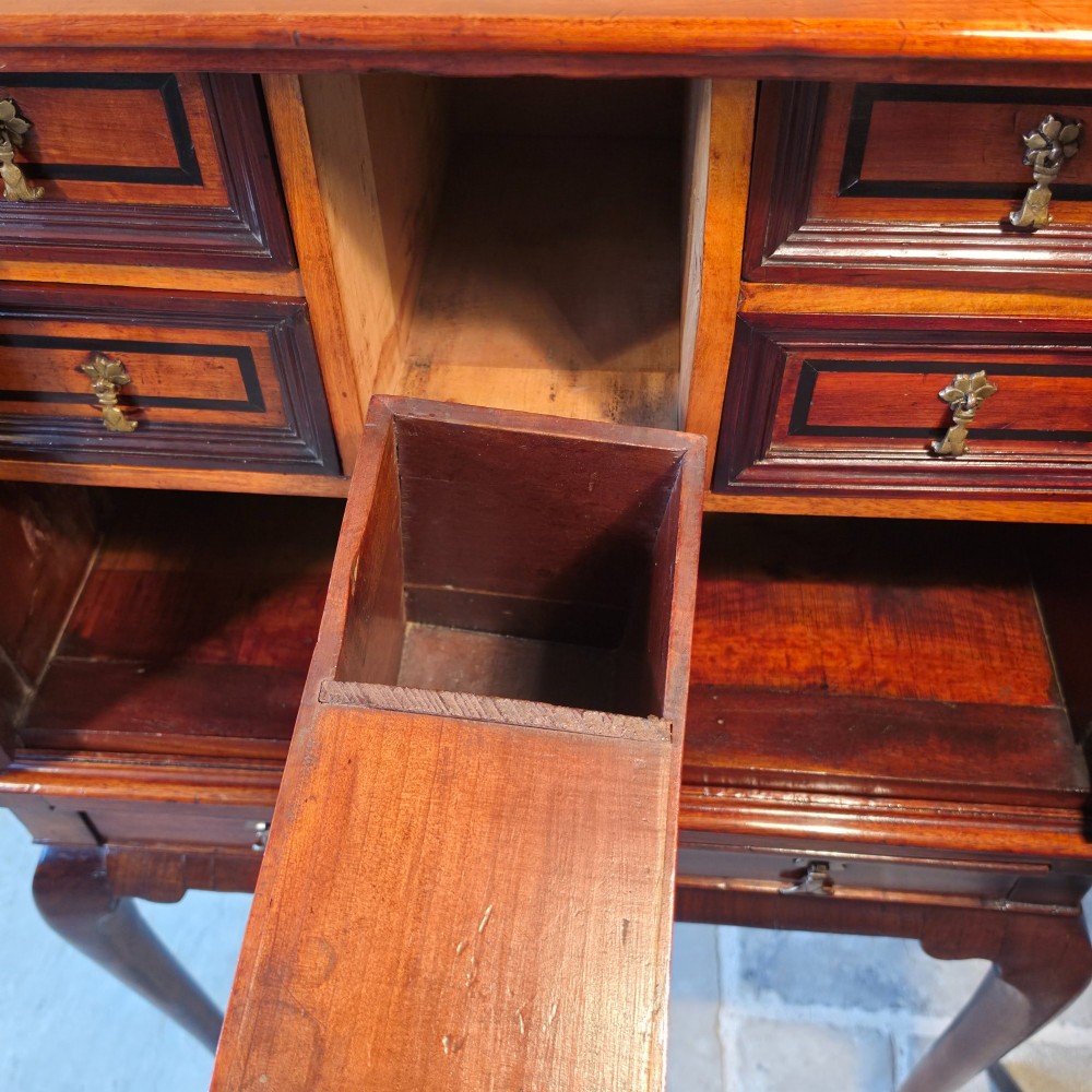 An 18th-century dark wood cabinet on stand featuring twin doors with black diamond inlay, a single lower drawer, and slender cabriole legs. View V