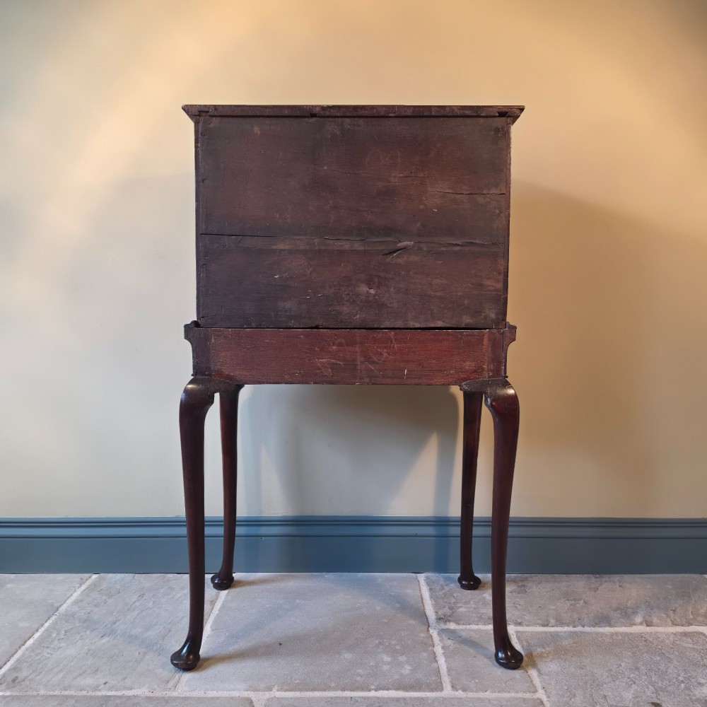 An 18th-century dark wood cabinet on stand featuring twin doors with black diamond inlay, a single lower drawer, and slender cabriole legs. View X