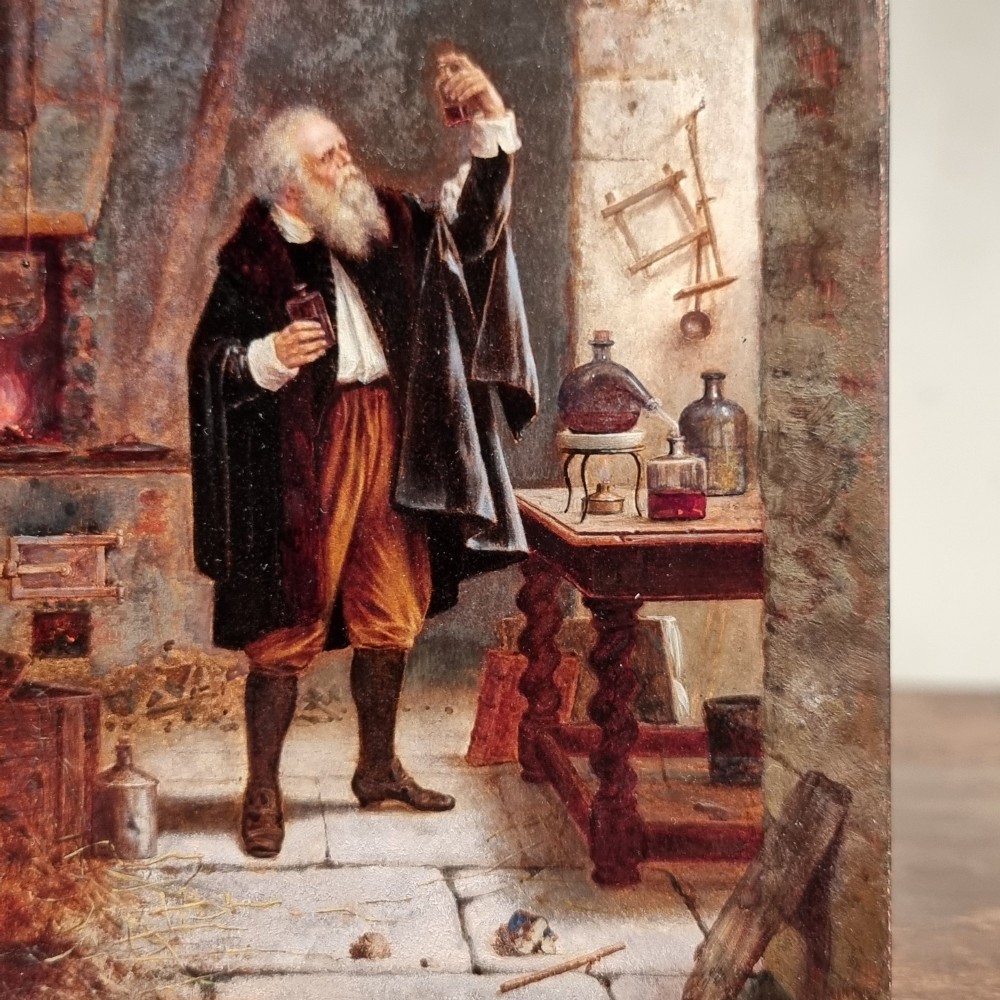An 18th-century oil painting on a wooden panel depicting a bearded alchemist examining a small glass flask inside a stone laboratory with a hearth and scientific apparatus. View II