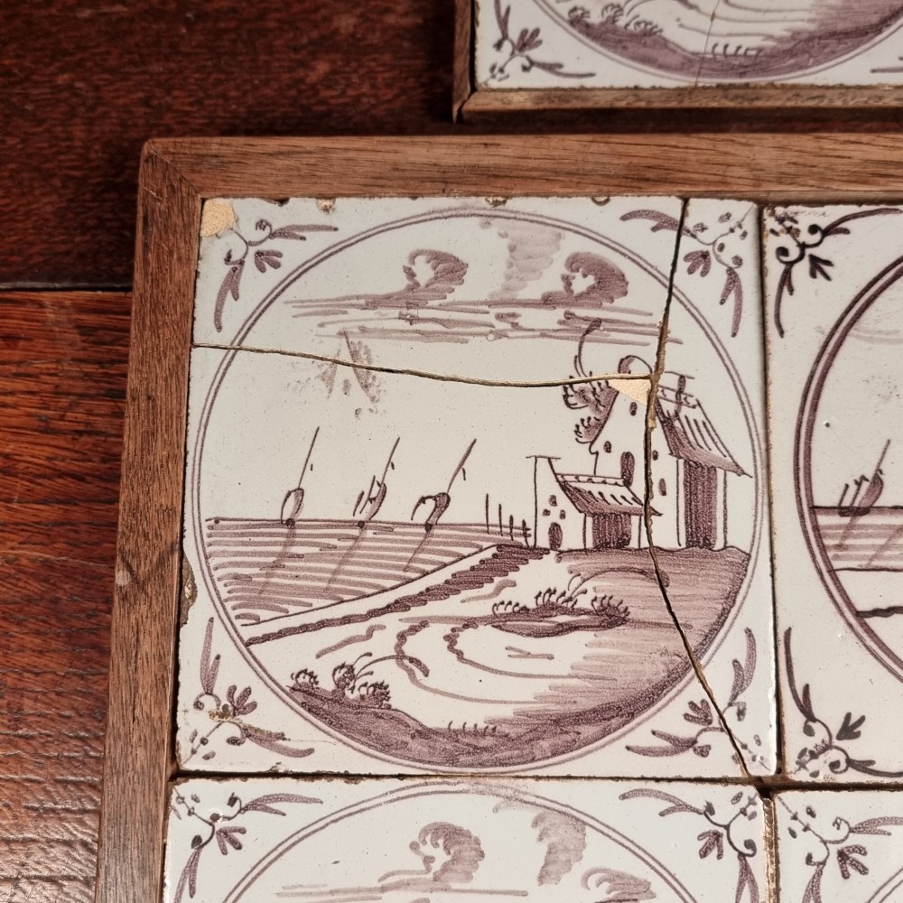 Ten eighteenth-century manganese delft tiles with hand-painted coastal landscapes set in circular reserves, mounted in two wooden frames. View II