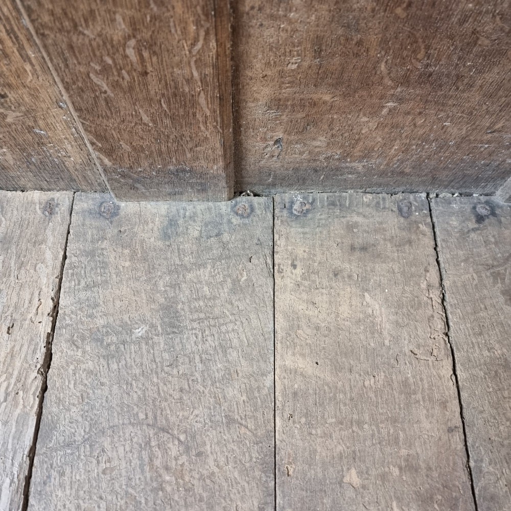 A late Elizabethan dark oak coffer with a rectangular hinged lid, iron lockplate, and panelled front facade. View XIV