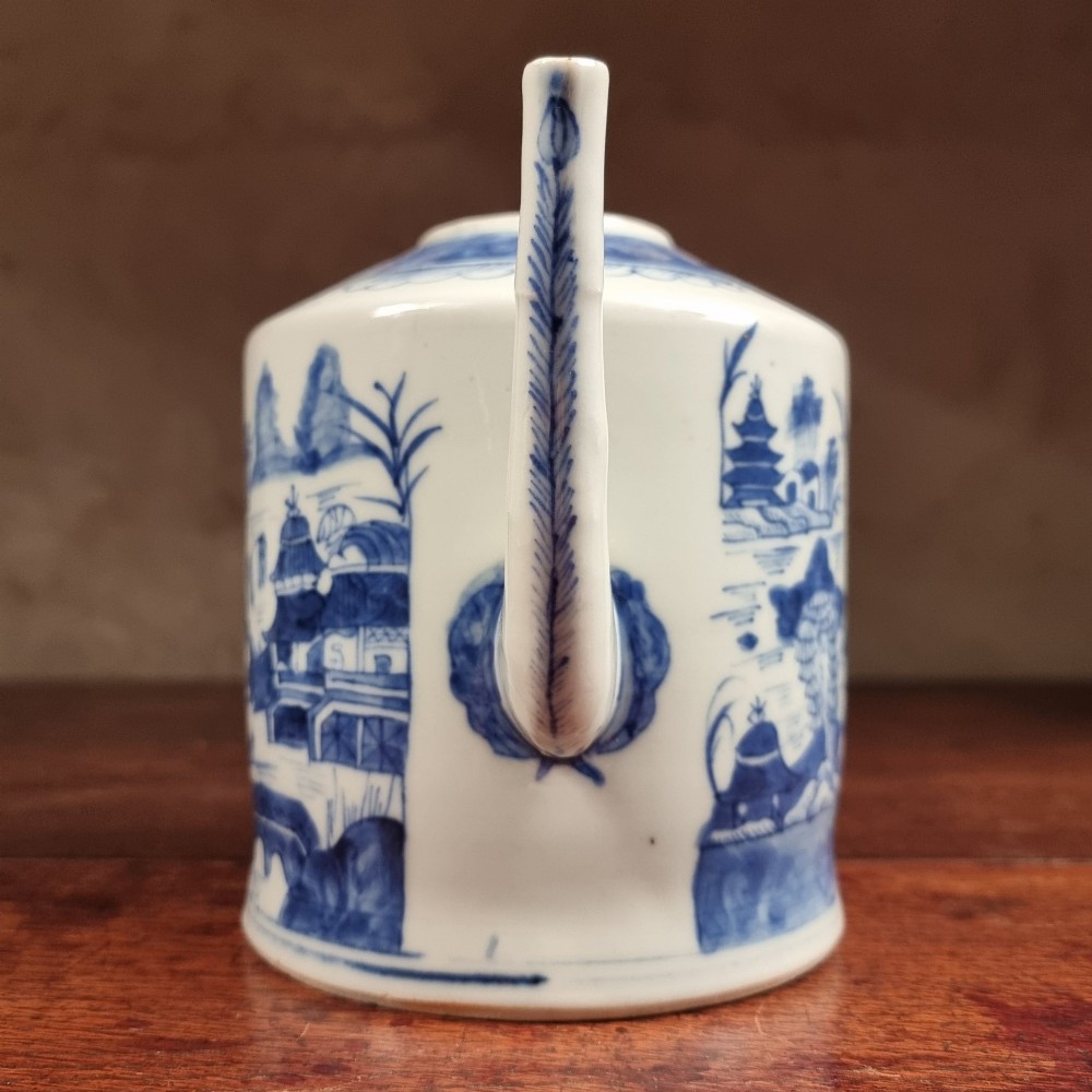 A cylindrical late 18th-century Chinese export porcelain teapot decorated with hand-painted blue and white underglaze river landscape scenes. View II