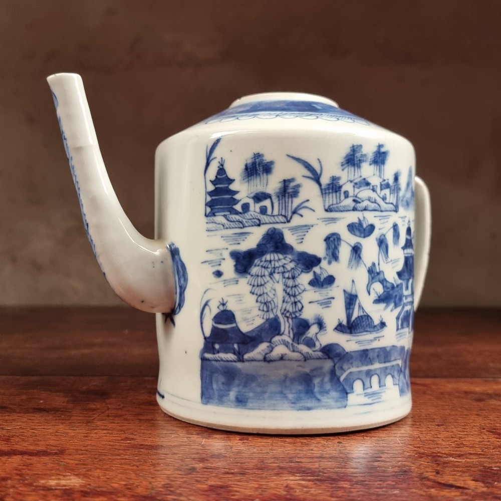 A cylindrical late 18th-century Chinese export porcelain teapot decorated with hand-painted blue and white underglaze river landscape scenes. View III