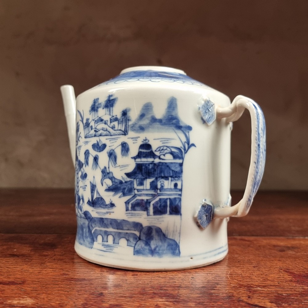 A cylindrical late 18th-century Chinese export porcelain teapot decorated with hand-painted blue and white underglaze river landscape scenes. View IV