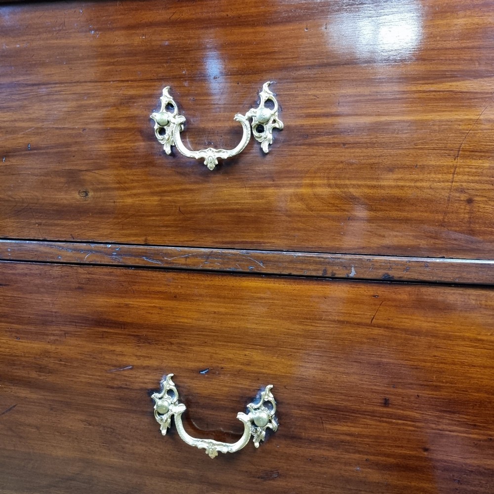 A 19th-century flame mahogany enclosed chest featuring twin doors framed with gilded metal moulding and corner mounts. View XII