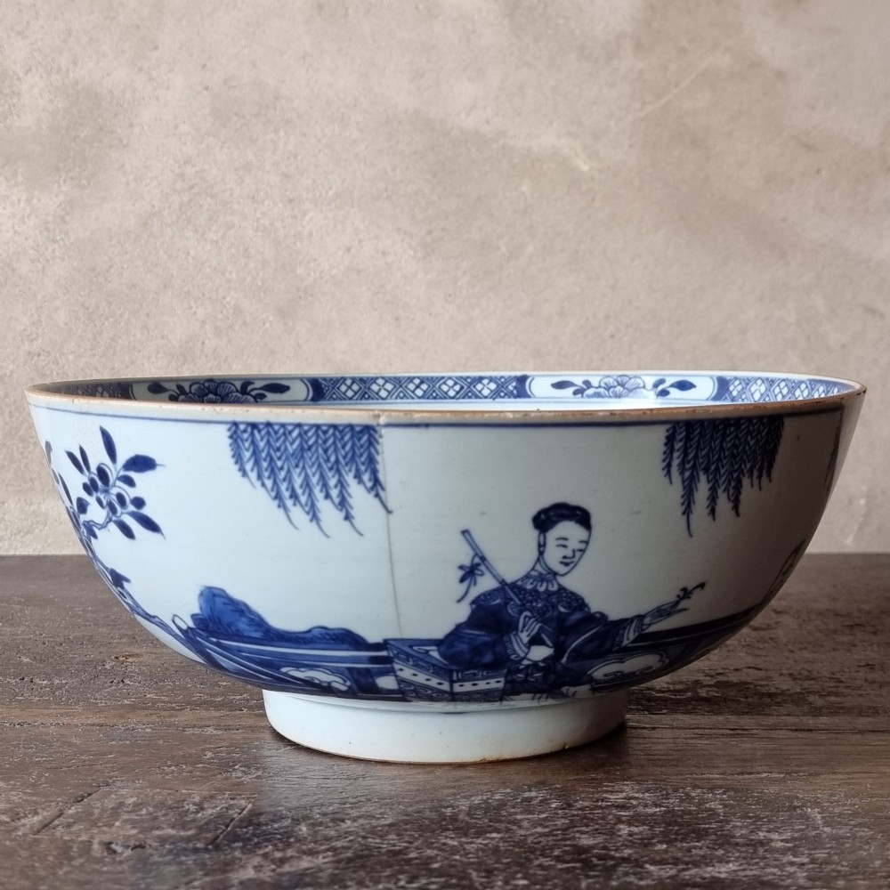 An 18th-century circular Chinese export porcelain punch bowl decorated with hand-painted blue figures under a willow tree. View VII