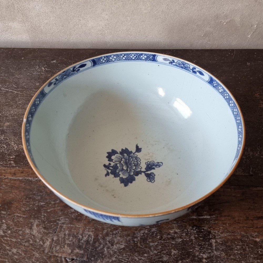 An 18th-century circular Chinese export porcelain punch bowl decorated with hand-painted blue figures under a willow tree. View VIII