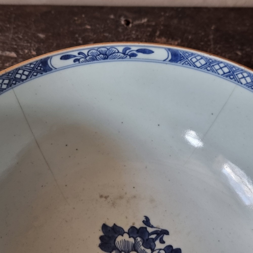 An 18th-century circular Chinese export porcelain punch bowl decorated with hand-painted blue figures under a willow tree. View IX