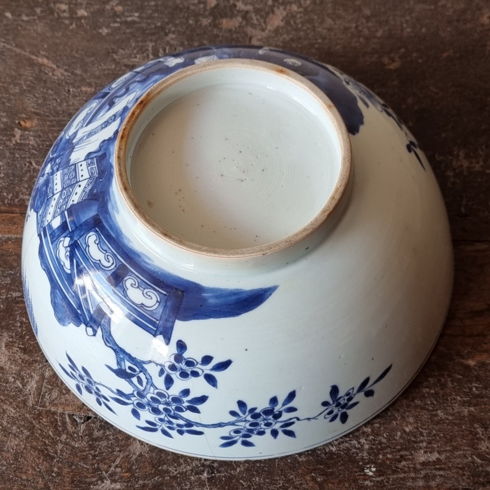 An 18th-century circular Chinese export porcelain punch bowl decorated with hand-painted blue figures under a willow tree. View XI
