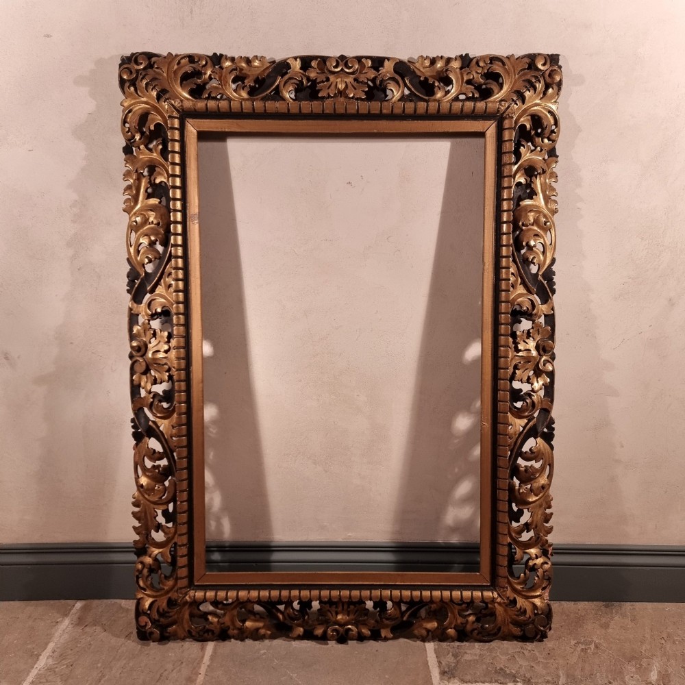 A large nineteenth-century rectangular giltwood frame featuring elaborate openwork acanthus leaf carvings and a gadrooned inner border. View II