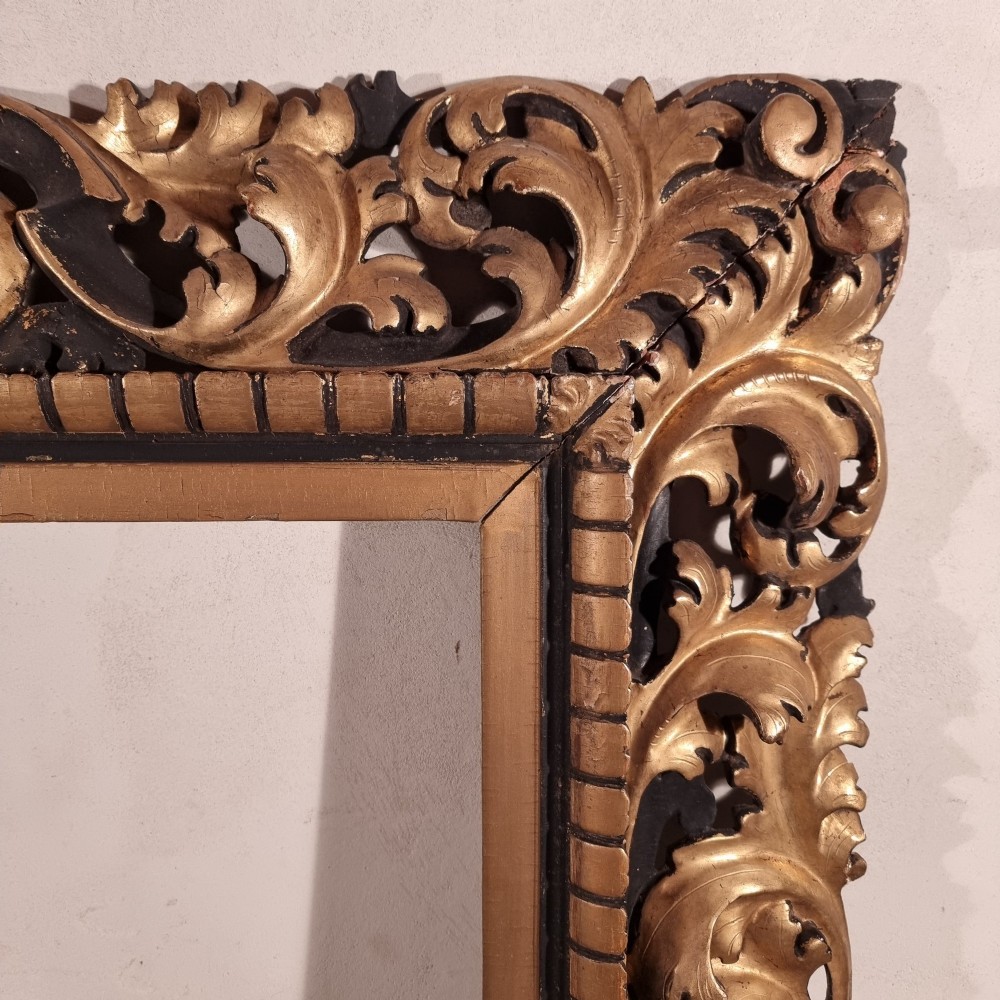 A large nineteenth-century rectangular giltwood frame featuring elaborate openwork acanthus leaf carvings and a gadrooned inner border. View V