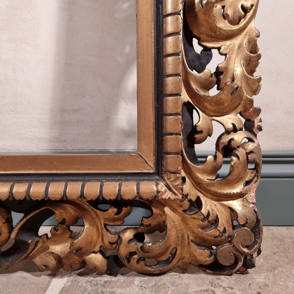 A large nineteenth-century rectangular giltwood frame featuring elaborate openwork acanthus leaf carvings and a gadrooned inner border. View VII