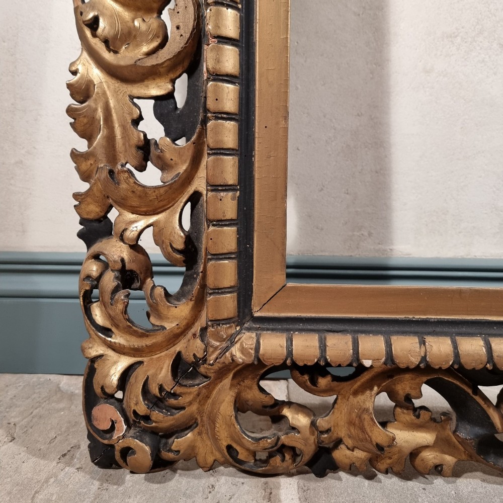 A large nineteenth-century rectangular giltwood frame featuring elaborate openwork acanthus leaf carvings and a gadrooned inner border. View IX