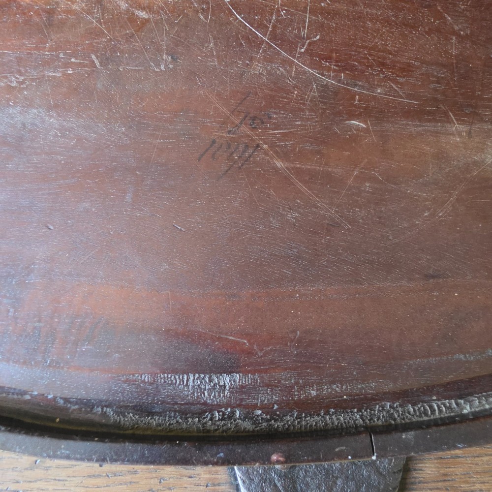 An 18th-century oval mahogany serving tray featuring a raised gallery edge with brass rim binding and carved scroll handles. View XIV