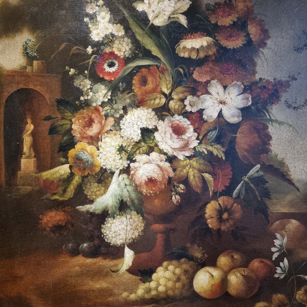 An 18th-century style oil painting on canvas depicting a floral arrangement in an urn with fruit at the base, housed within a gilded wooden frame. View IV