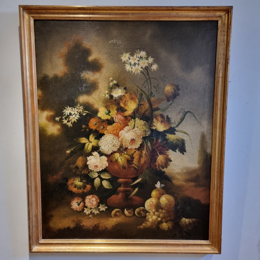 An 18th-century style oil painting on canvas depicting a floral arrangement in an urn with fruit at the base, housed within a gilded wooden frame. View VII