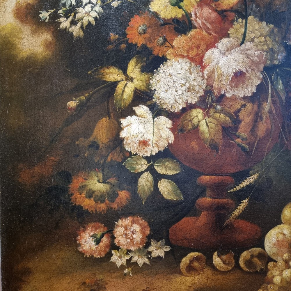 An 18th-century style oil painting on canvas depicting a floral arrangement in an urn with fruit at the base, housed within a gilded wooden frame. View XI