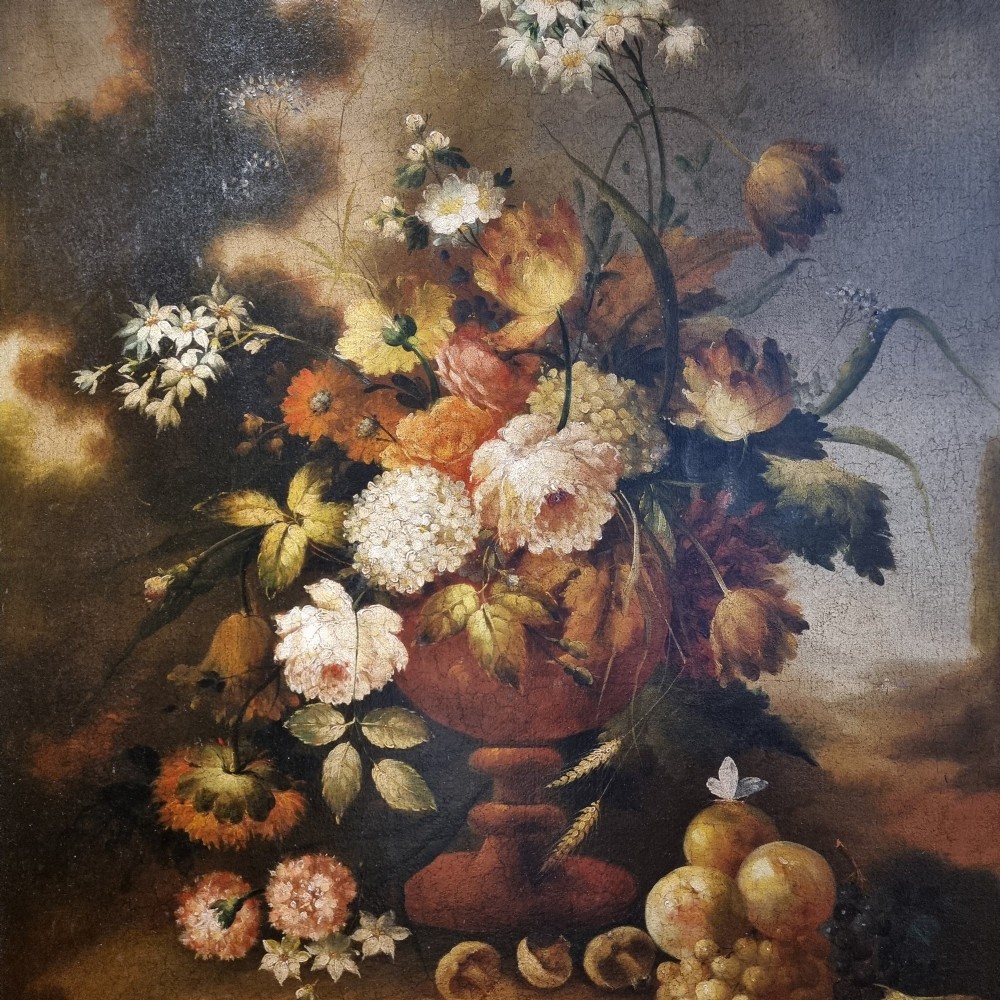 An 18th-century style oil painting on canvas depicting a floral arrangement in an urn with fruit at the base, housed within a gilded wooden frame. View XII