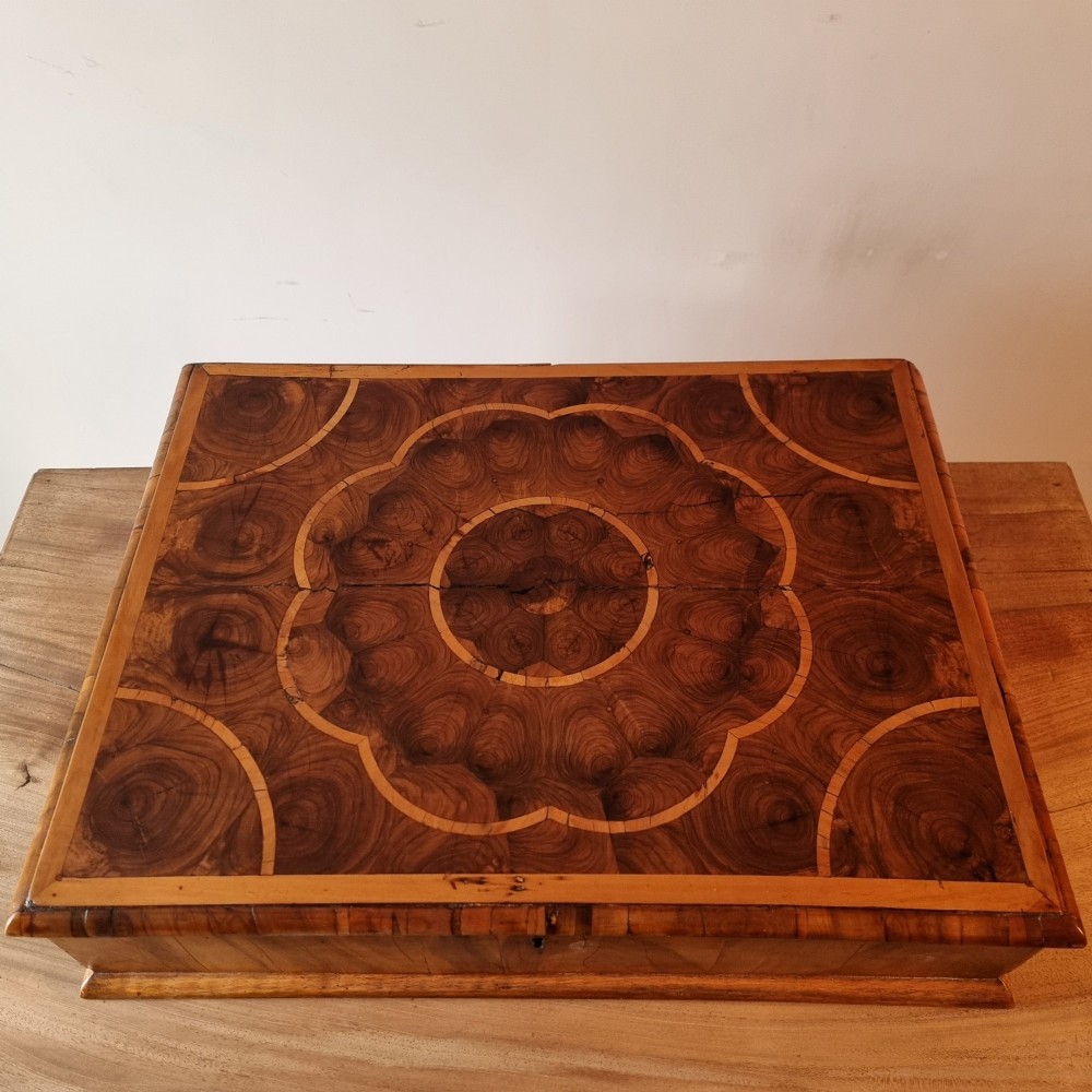 A rectangular William and Mary period walnut lace box featuring concentric oyster veneer patterns on the hinged lid. View VII