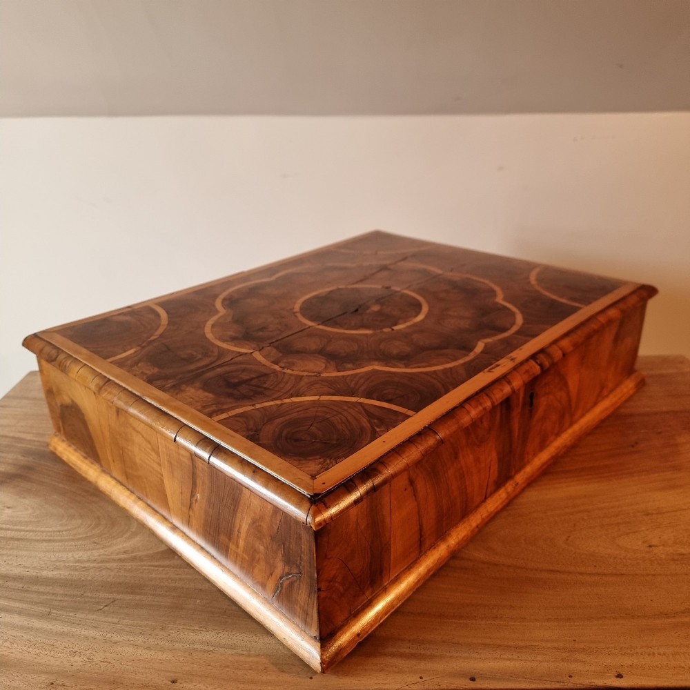 A rectangular William and Mary period walnut lace box featuring concentric oyster veneer patterns on the hinged lid. View VIII