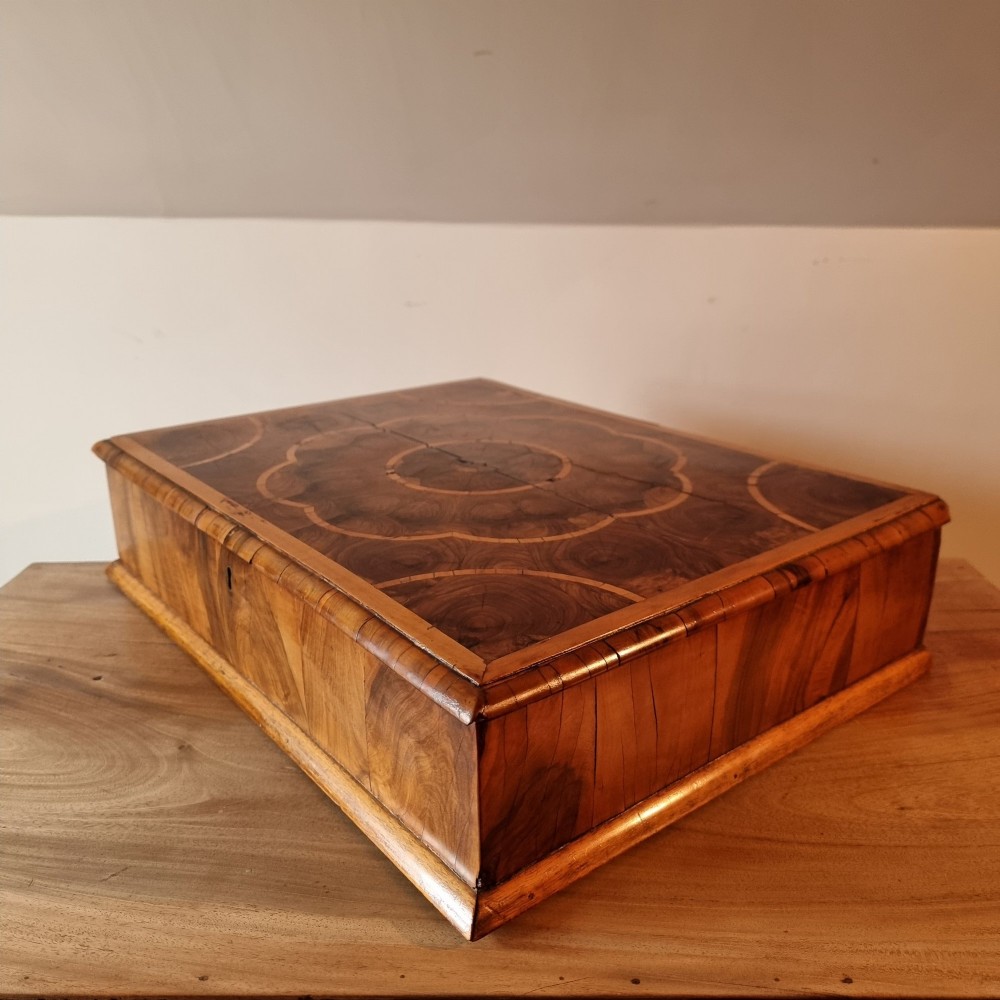 A rectangular William and Mary period walnut lace box featuring concentric oyster veneer patterns on the hinged lid. View IX