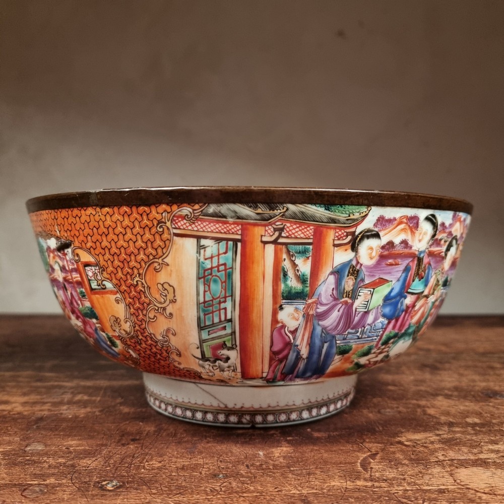 A 19th-century Chinese porcelain bowl featuring hand-painted polychrome figural scenes and a metal-bound rim. View II
