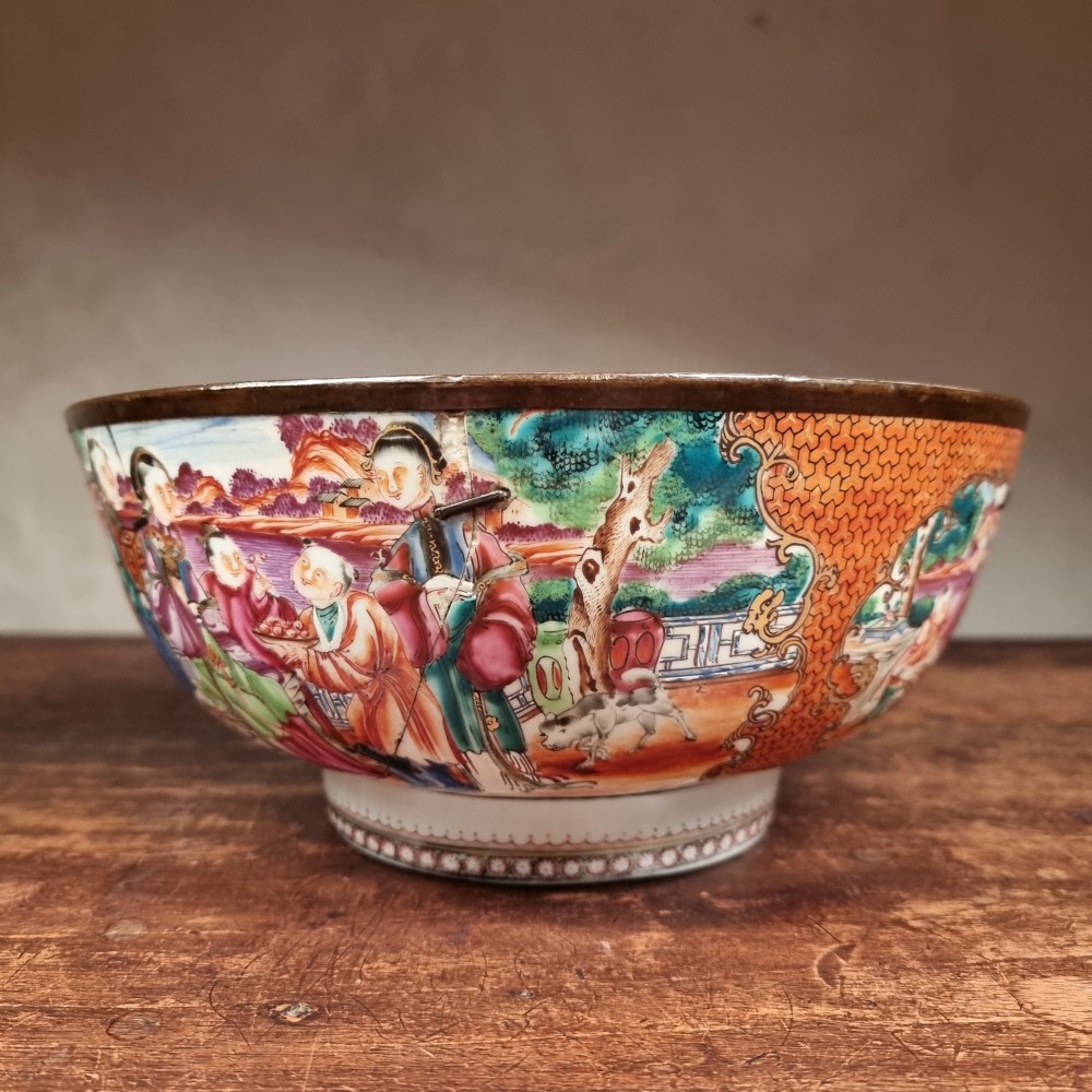 A 19th-century Chinese porcelain bowl featuring hand-painted polychrome figural scenes and a metal-bound rim. View IV