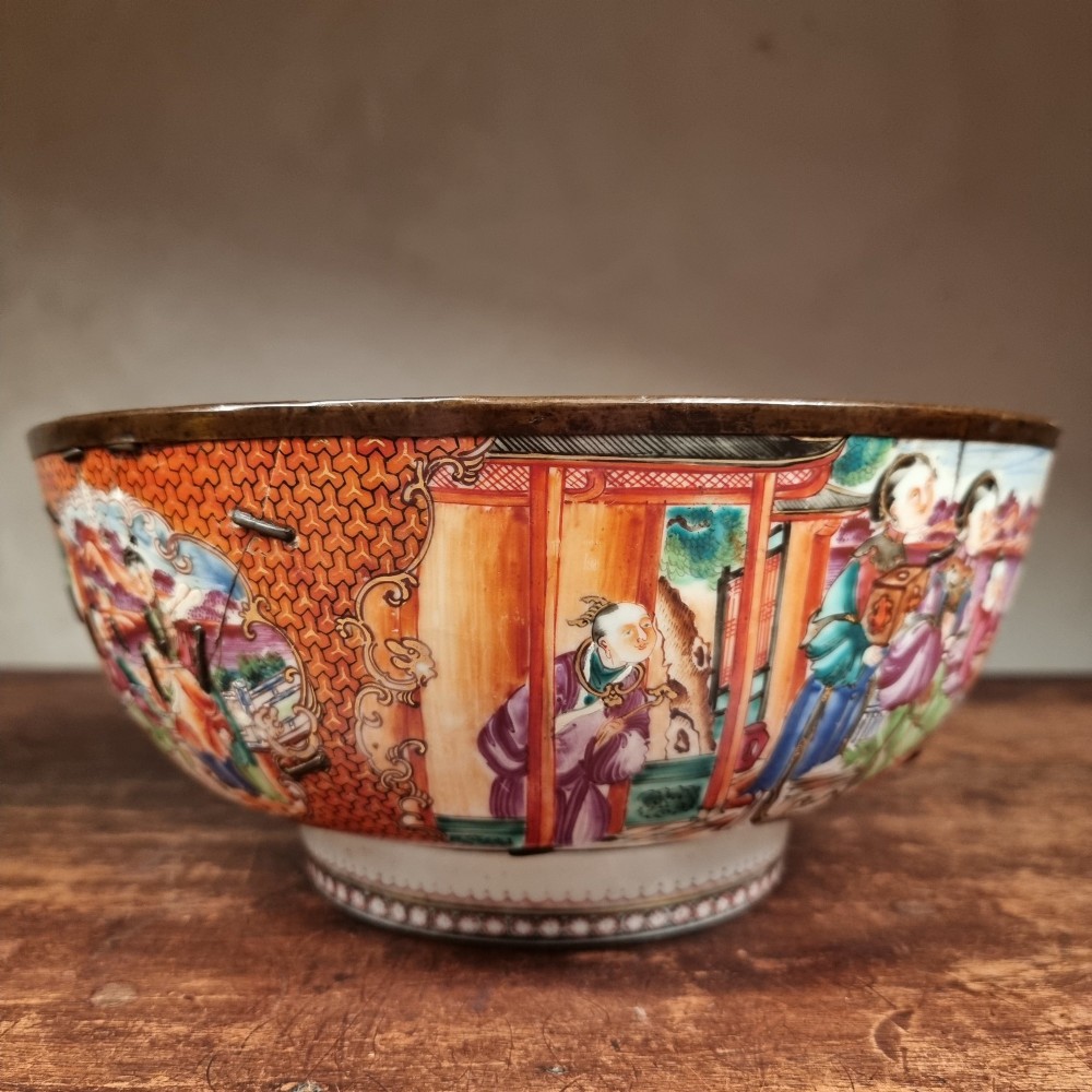 A 19th-century Chinese porcelain bowl featuring hand-painted polychrome figural scenes and a metal-bound rim. View VI