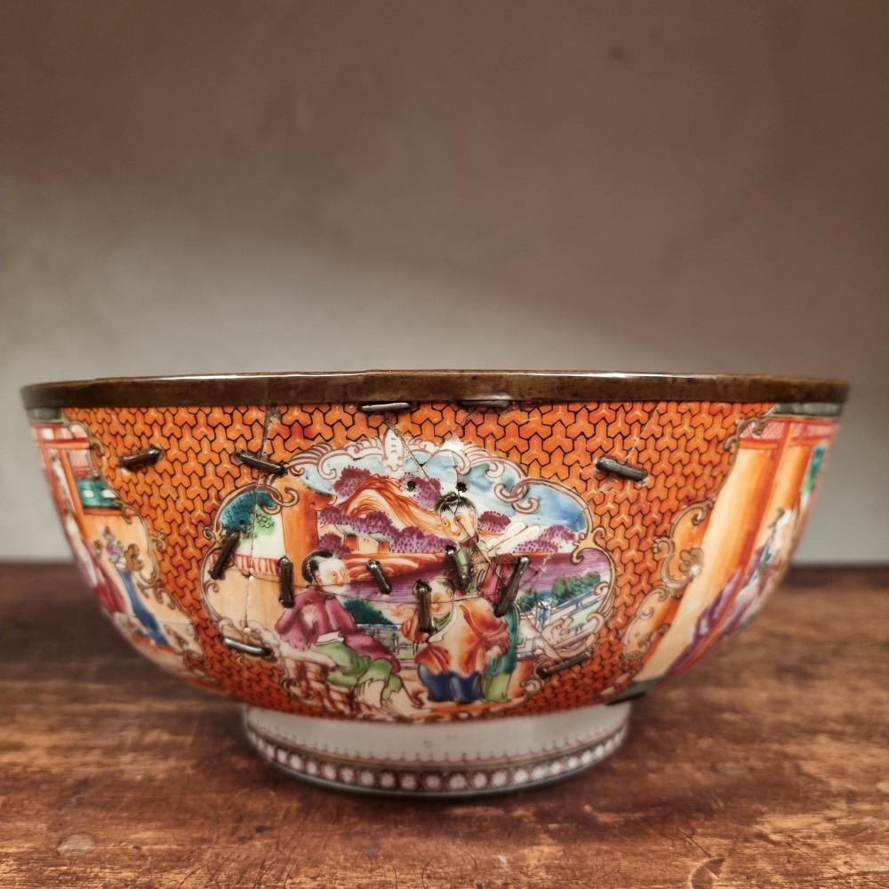 A 19th-century Chinese porcelain bowl featuring hand-painted polychrome figural scenes and a metal-bound rim. View VII