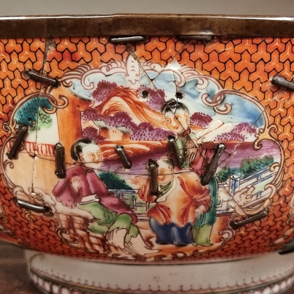 A 19th-century Chinese porcelain bowl featuring hand-painted polychrome figural scenes and a metal-bound rim. View VIII