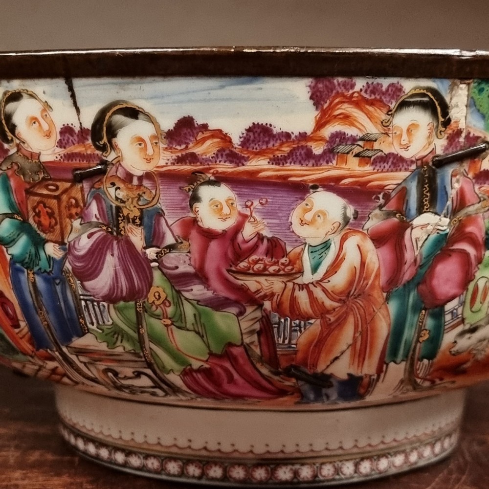 A 19th-century Chinese porcelain bowl featuring hand-painted polychrome figural scenes and a metal-bound rim. View IX