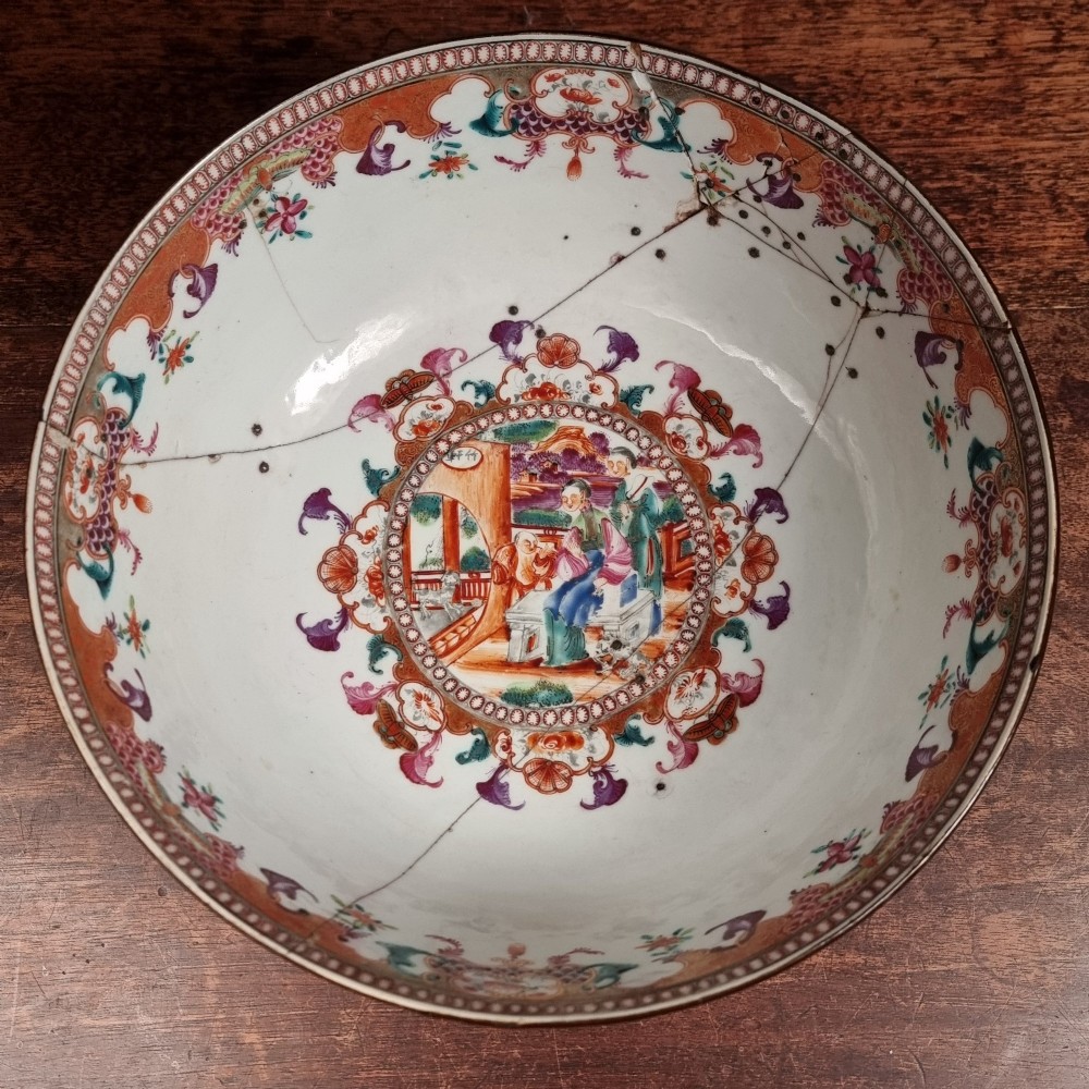 A 19th-century Chinese porcelain bowl featuring hand-painted polychrome figural scenes and a metal-bound rim. View XII