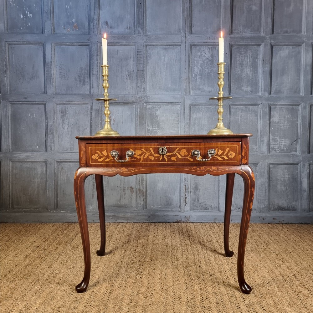 An 18th-century warm brown timber centre table with intricate floral marquetry inlay across the single drawer front, apron, and slender cabriole legs. View II