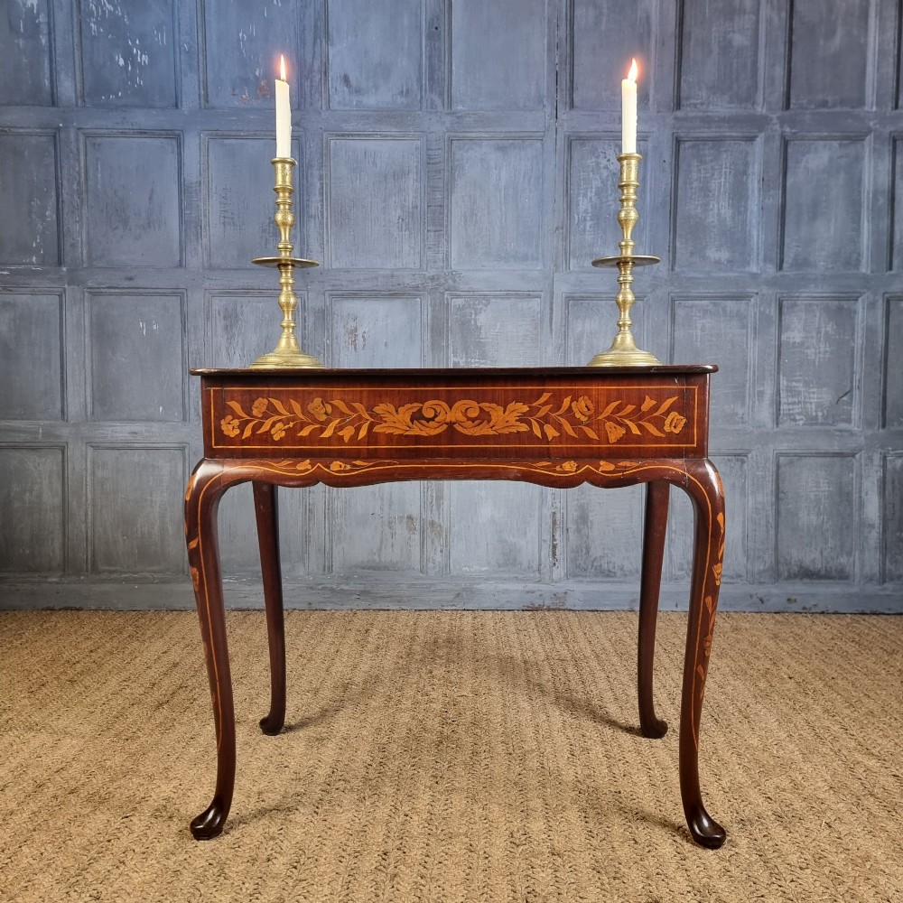 An 18th-century warm brown timber centre table with intricate floral marquetry inlay across the single drawer front, apron, and slender cabriole legs. View III