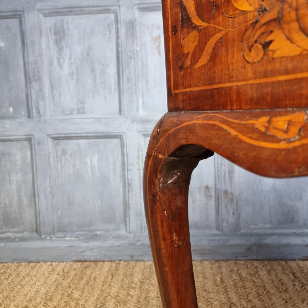 An 18th-century warm brown timber centre table with intricate floral marquetry inlay across the single drawer front, apron, and slender cabriole legs. View VI