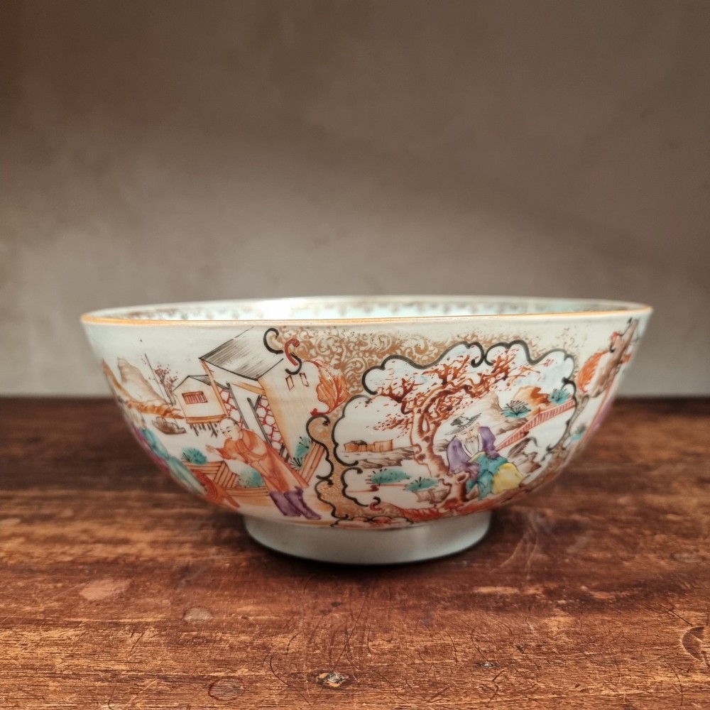 A 19th-century Chinese porcelain bowl hand-painted with polychrome enamels depicting figures in a garden landscape against an off-white background. View II