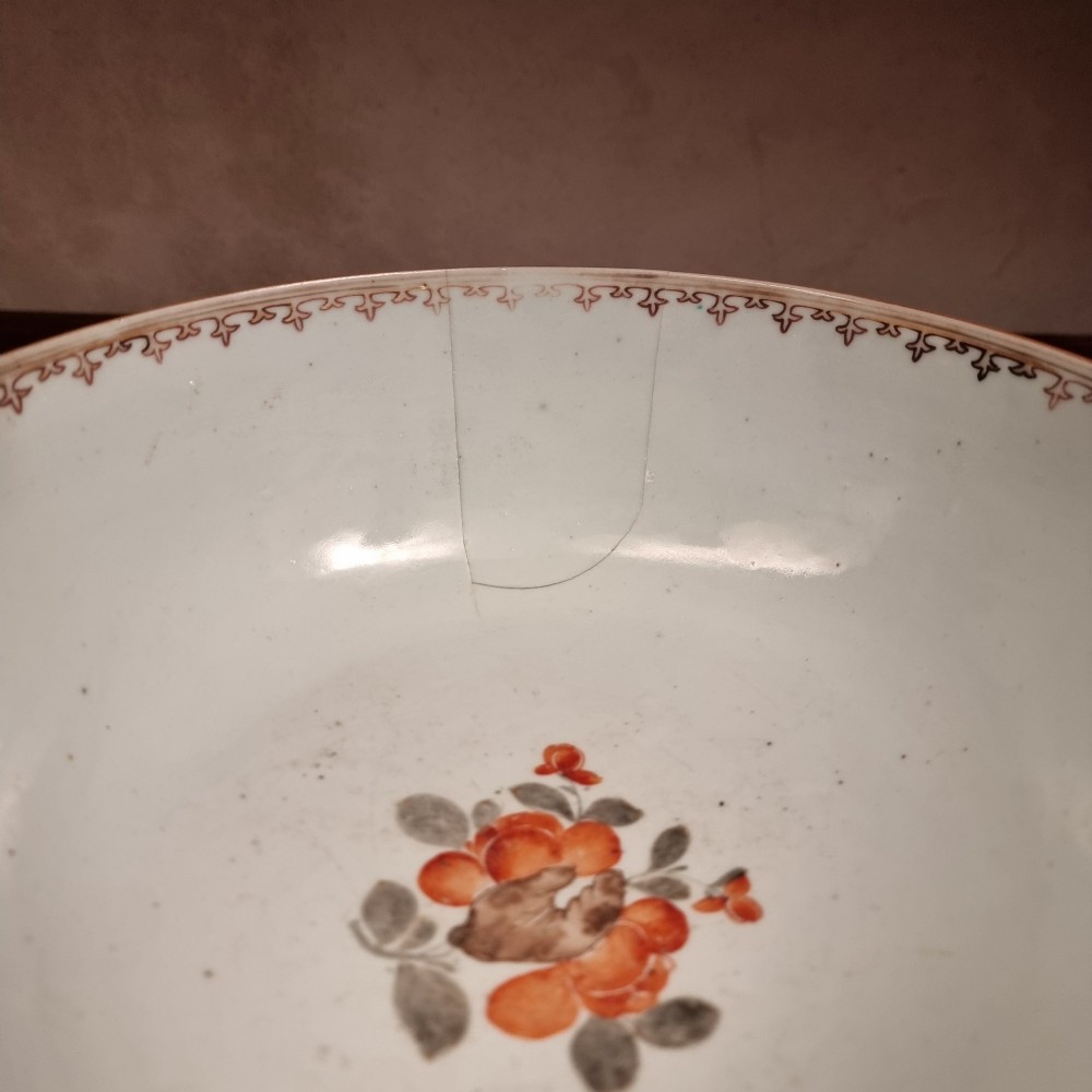 A 19th-century Chinese porcelain bowl hand-painted with polychrome enamels depicting figures in a garden landscape against an off-white background. View VI