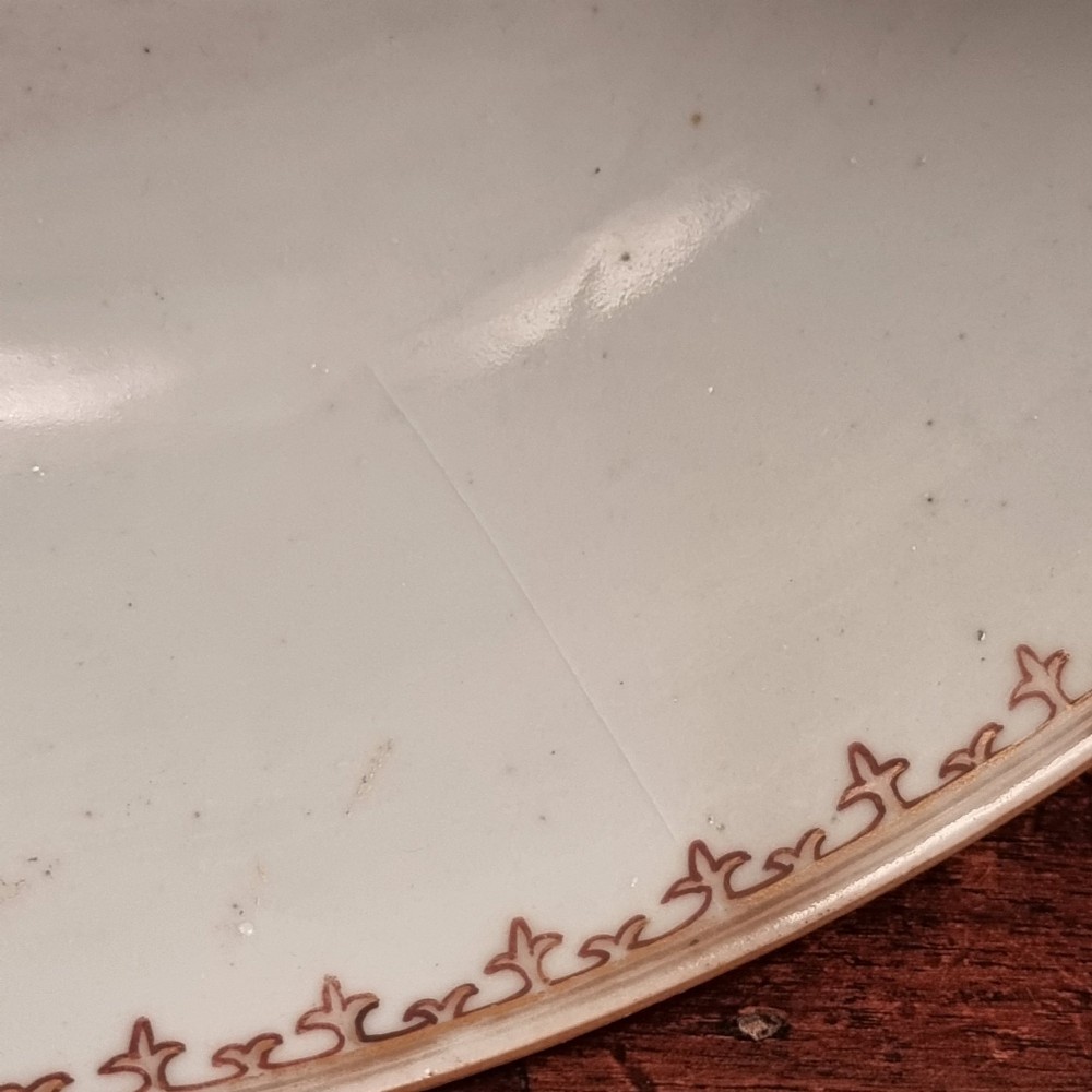 A 19th-century Chinese porcelain bowl hand-painted with polychrome enamels depicting figures in a garden landscape against an off-white background. View VII