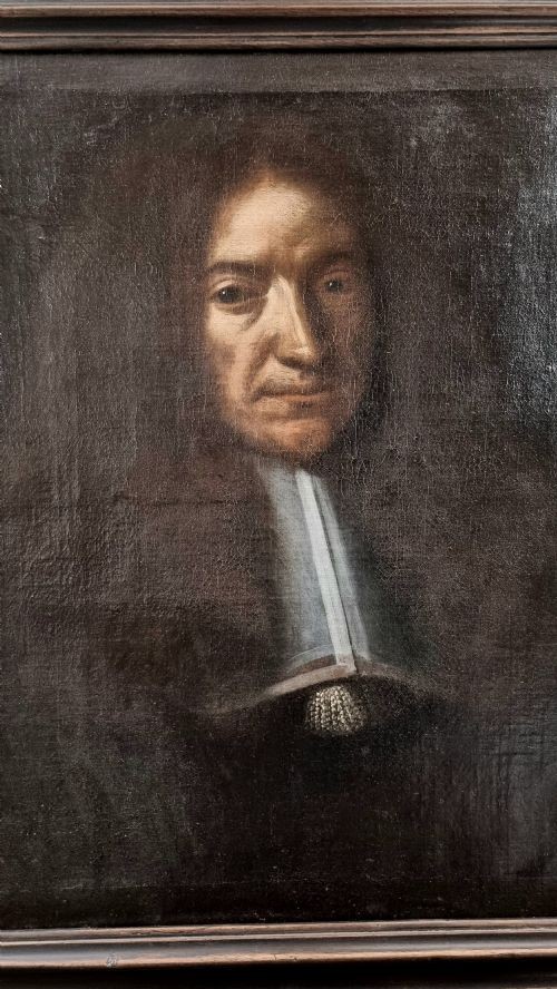 A 17th-century oil portrait painting depicting a French judge wearing a white collar and full dark wig set inside a dark moulded wooden frame. View V