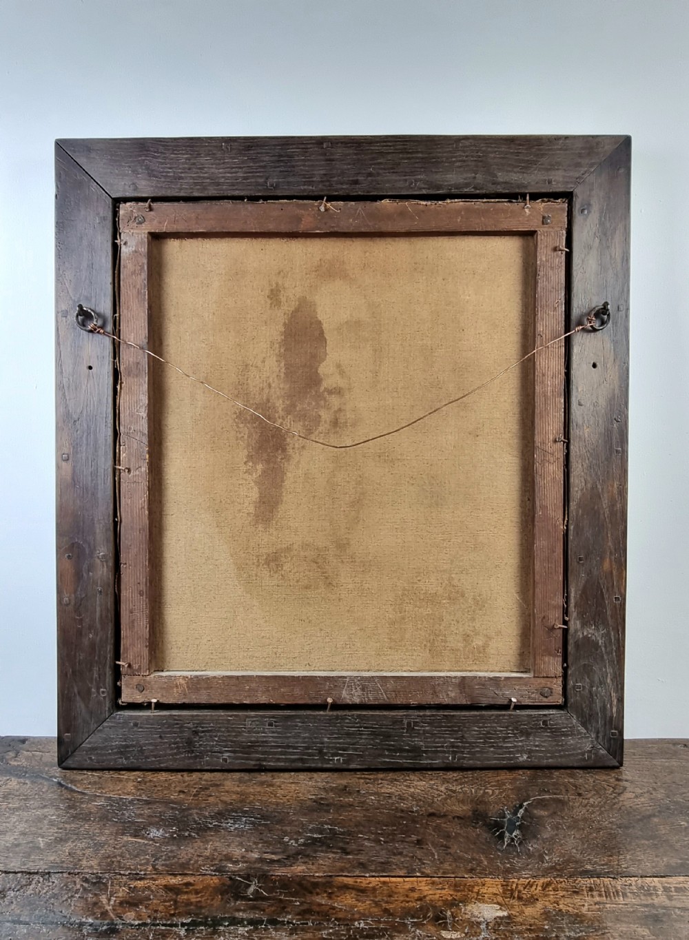 A 17th-century oil portrait painting depicting a French judge wearing a white collar and full dark wig set inside a dark moulded wooden frame. View VI