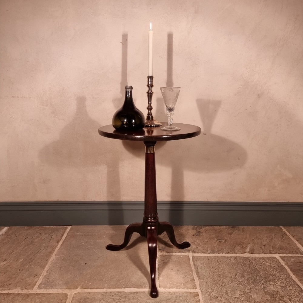 A dark mahogany 18th-century wine table featuring a circular top, turned central pedestal, and three cabriole tripod legs. View II