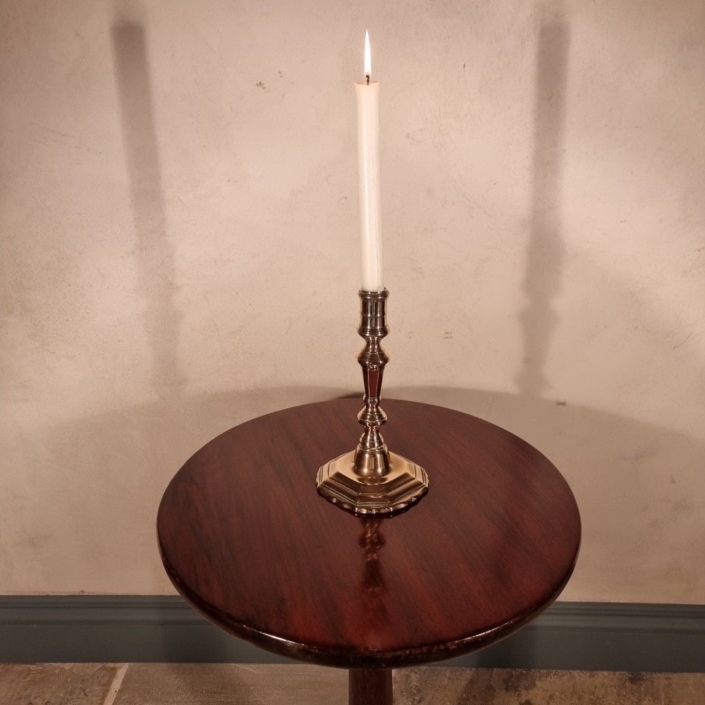 A dark mahogany 18th-century wine table featuring a circular top, turned central pedestal, and three cabriole tripod legs. View III