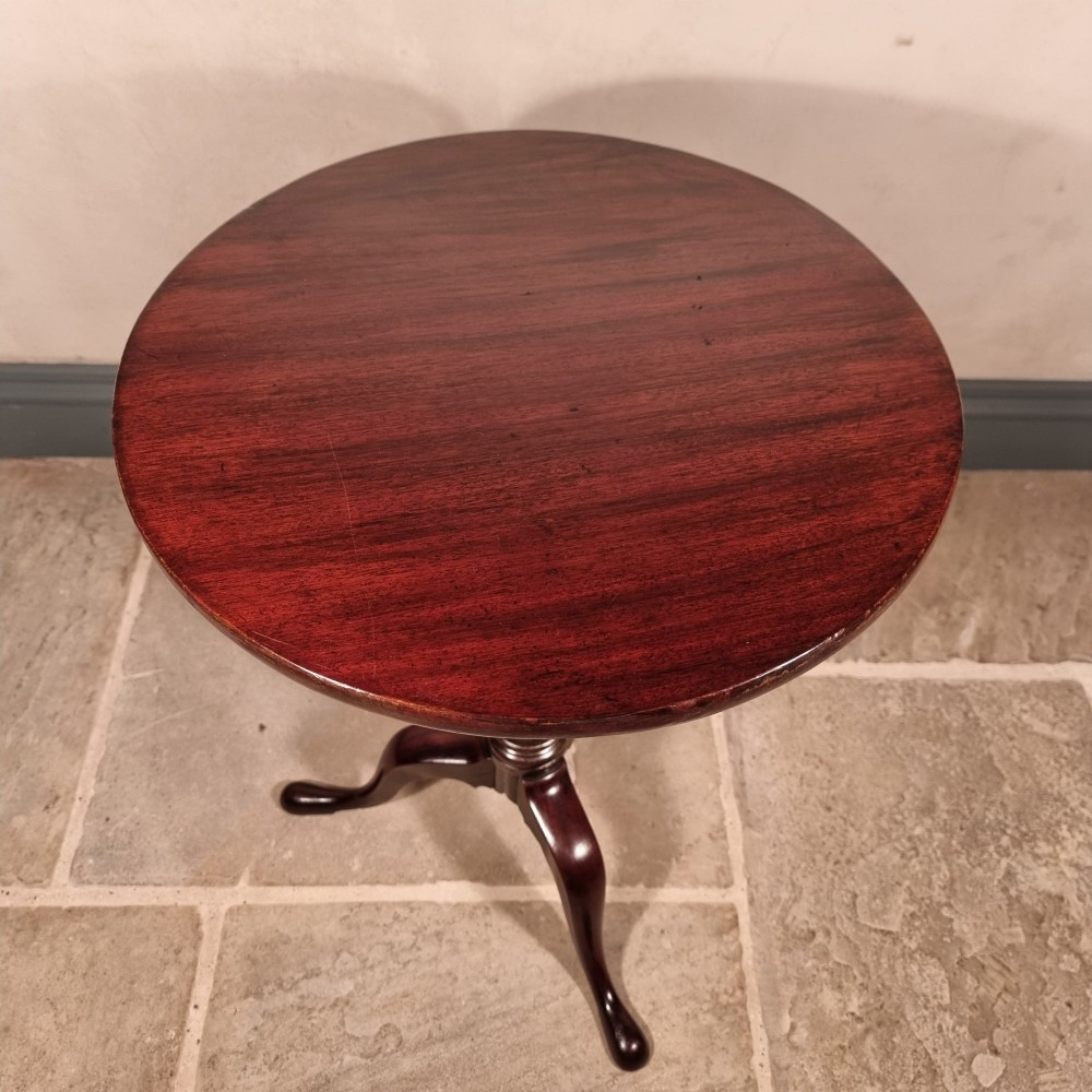 A dark mahogany 18th-century wine table featuring a circular top, turned central pedestal, and three cabriole tripod legs. View VI