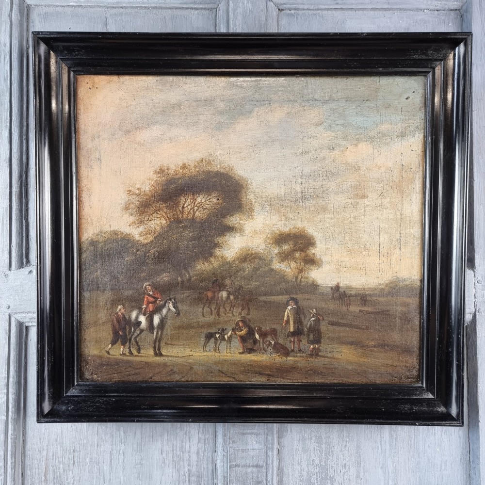 A late 17th-century oil painting on canvas depicting figures with horses and dogs in a pastoral landscape, housed in a black ebonised wooden frame.