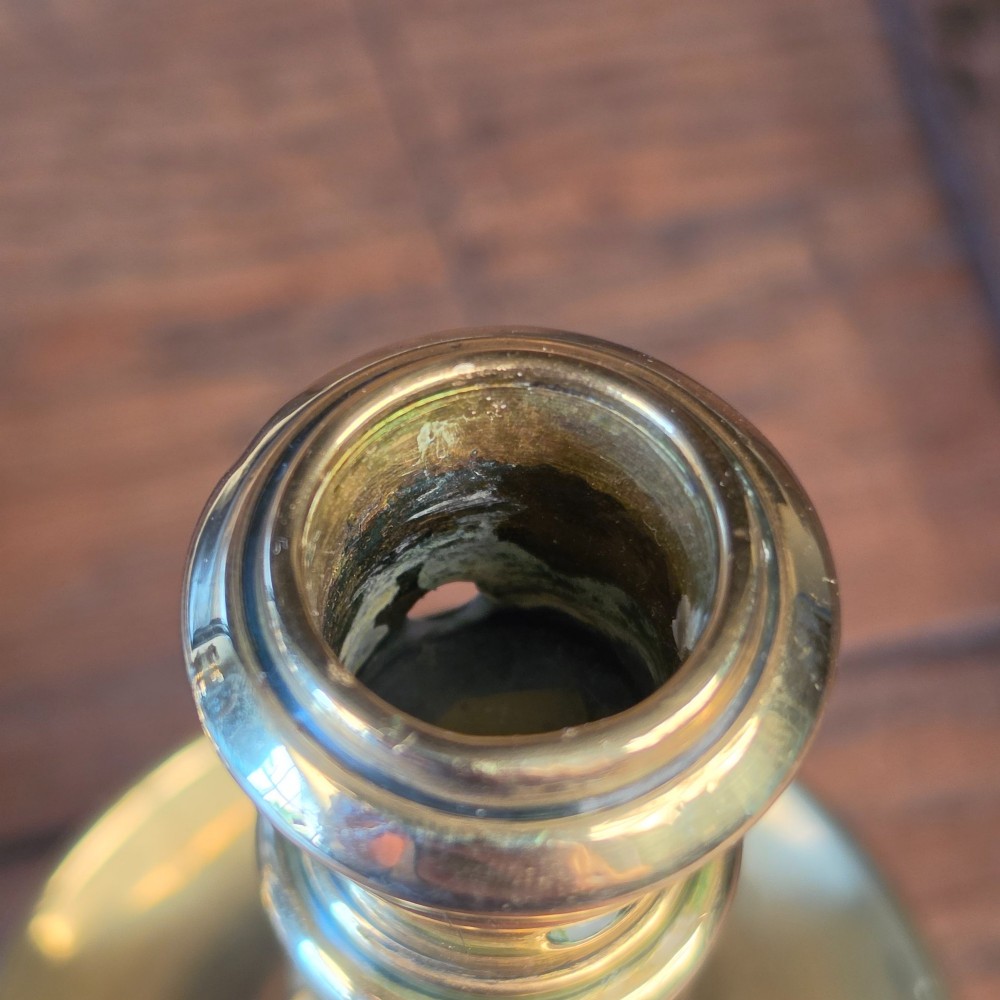 A pair of small turned brass candlesticks featuring flared circular bases, baluster stems, and sockets with wax removal holes. View VIII